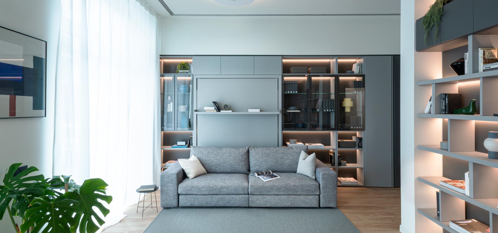 Clei sofa integrated with the transformable bed system with wood paneling